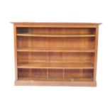 An oak open bookcase, the outswept pediment over three shelves, raised on a plinth base, 122cm H,