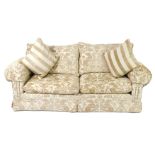 A Duresta two seater sofa, upholstered in fawn Gothic vine and lion fabric, together with two