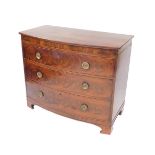 A George III mahogany bow front chest of drawers, with three long graduated drawers raised on
