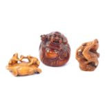 Two Japanese late 20thC carved wooden netsuke, signed, one with two frogs on a lily pad in an arm