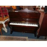 An early 20thC mahogany cased upright piano, G A Buckland & Company London, iron framed, 116cm H,