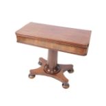 A late Regency mahogany fold over tea table, raised on a cylindrical column and quatrefoil base,