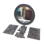 A cast iron circular wall mirror, 49cm Dia., a pair of cast iron wall plaques decorated in relief