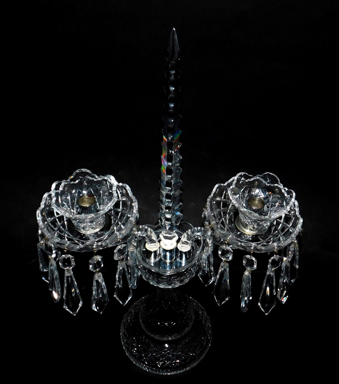 A Waterford crystal twin branch candelabrum, with a central faceted spike and faceted drops,