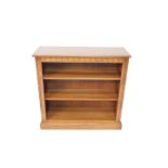 An Ercol oak open bookcase, with two shelves raised on a plinth base, 92.5cm H, 96cm W, 34cm D.