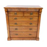 A Victorian flame mahogany chest of drawers, the outswept pediment over two short over five long