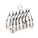 A silver six division toast rack, formed as fourteen crossed rifles, London 2000, 10.09oz.