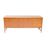 A Nathan teak sideboard, with three doors flanked to the right by three graduated drawers, raised on