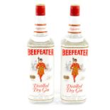 Two bottles of Beefeater distilled dry gin, imported by James Burrough Ltd. London.