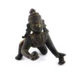 A Chola bronze figure of Krishna, modelled crawling with a butter ball, 6cm L.