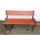 A garden bench with cast metal ends and wooden slats, 120cmW.