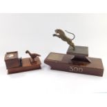 An early 20thC Egyptian rosewood novelty cigarette dispenser, modelled with a bird, 18cm W, together