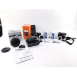 A Fuji Film Digital camera, Finepix S4700, Sony flash SVL-F42AM, two Olympus lens, a Tamaron Versoni