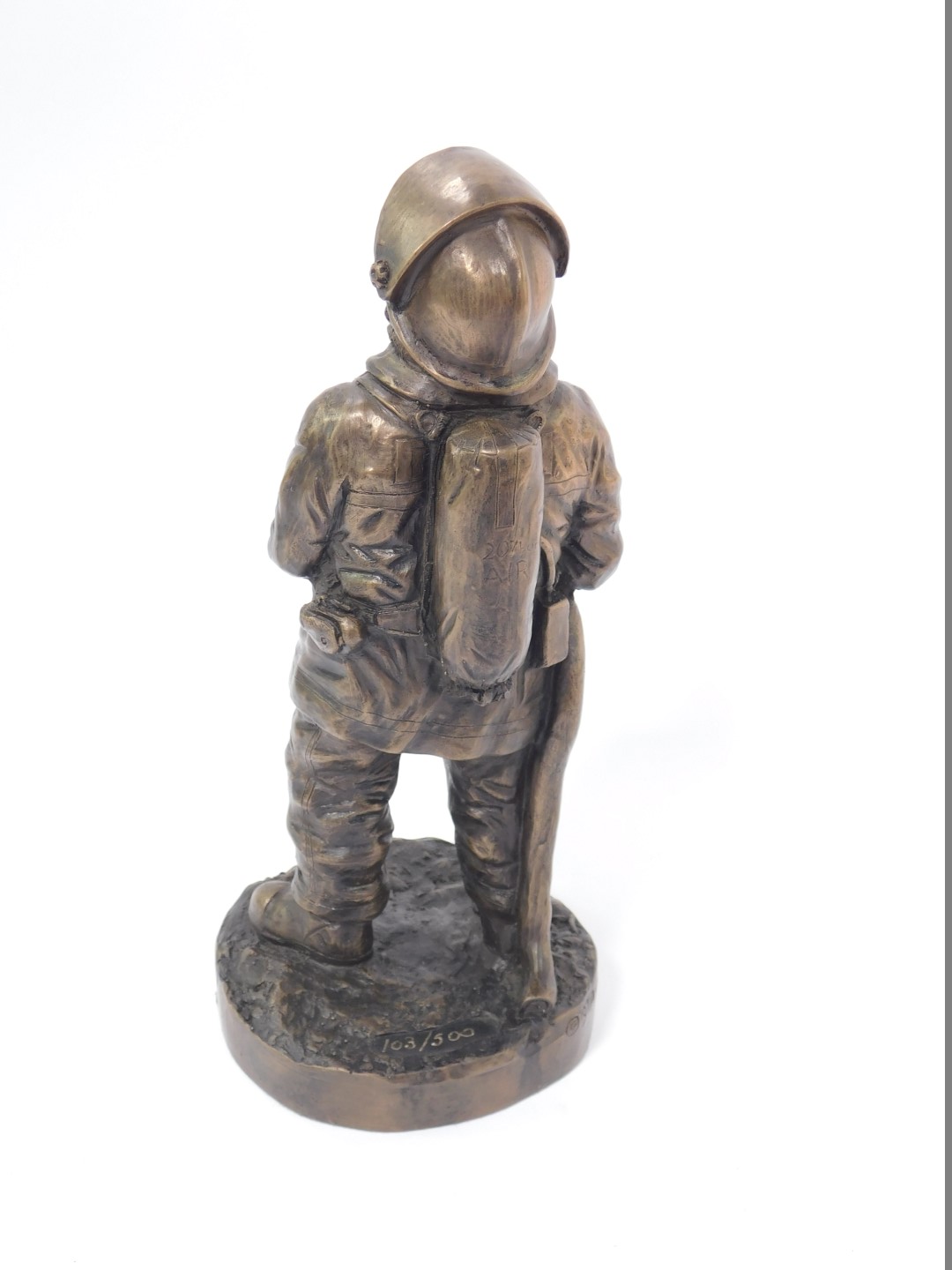 A late 20thC bronzed plaster figure modelled as a fire fighter, raised on a circular base, limited - Image 2 of 3