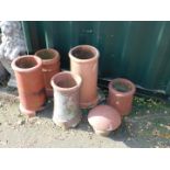 Five terracotta chimney pots, various heights, together with a topper. (6)