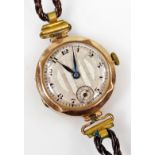 A 9ct gold ladies wristwatch, in the 1930's style, with brown leather strap.