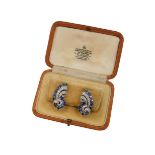 A pair of Garrard & Company mid 20thC sapphire and diamond ear or lapel clips, of scrolling form set