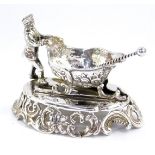 A continental late 19thC silver novelty salt, modelled as a man pushing a troika, embossed with