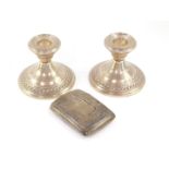 A pair of loaded silver squat candlesticks, hallmarks worn, 13.02oz all in, 7cm H, together with