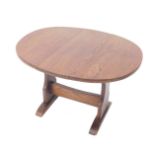 An early 20thC oak drop leaf occasional table, raised on trestle and supports, united by a