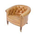 A Victorian style mahogany framed tub armchair, upholstered in button back tan leather, raised on