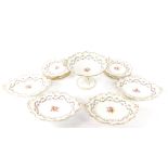 A mid 19thC porcelain dessert service, painted with floral sprays within garlands of flowers, gilt