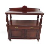 A Victorian mahogany buffet or waiter, having shelf back and moulded top, on taper reeded columns,