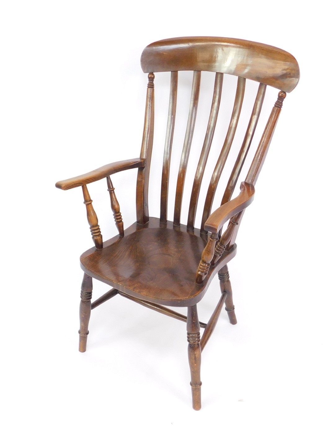 A Victorian oak and elm lath back kitchen chair, with turned arms and solid saddle seat, raised on