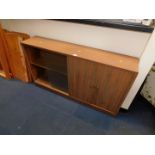 A Morris of Glasgow (Cumbrae Furniture) teak low bookcase cabinet, with glass sliding doors,
