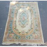 A Chinese floral rug, against a turquoise ground within a cream border, 317cm x 211cm.