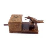A novelty wooden cigarette box, modelled with a bird on a barrel raised on a rectangular base,