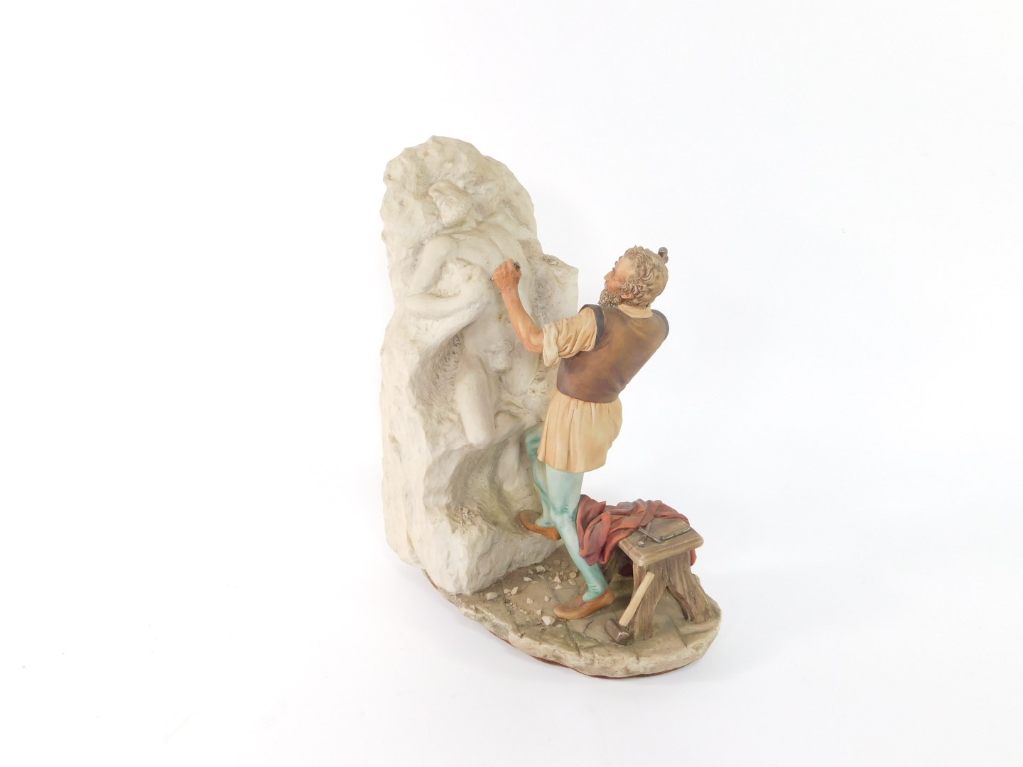 A Capodimonte porcelain figure of Michelangelo, modelled standing carving a sculpture, limited
