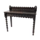 A Victorian oak side table, with a carved back, front and side friezes, side drawer, raised on