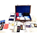 Masonic jewels and ephemera, some silver gilt or gold, many cased, in a brown leather case.