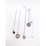 Five silver and costume jewellery pendants on chains.