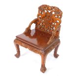 A Chinese carved hardwood dragon armchair, the back with two dragons and a flaming pearl, central
