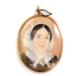 A Victorian portrait miniature of a lady, in an oval gilt metal mount, verso centred with crossed