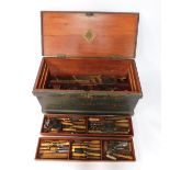A carpenter's pine tool chest, containing an assortment of chisels, planes, braces, and other tools,
