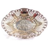 A continental silver oval basket, white metal, of pierced high sided form, embossed with putti and