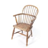 A Victorian oak and elm Windsor chair, the solid seat with tapestry overlay, raised on turned