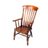 A Victorian oak and elm lath back kitchen chair, with a solid saddle seat, raised on turned legs