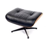 An Eames style walnut veneered foot stool, with buttoned black leather upholstery, raised on a metal