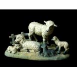 A Carlton Glacielle ware figure group, of lambs, modelled standing and recumbent on a naturalistic