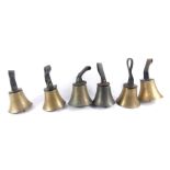 Six hand bells with hammers, one lacking, tooled leather handles.