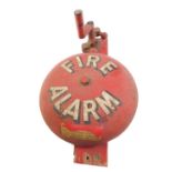 A vintage wall mounted fire alarm, red metal with winder mechanism clanger, bears part decal, Fire
