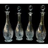 A set of four cut glass decanters and stoppers, of slender necked baluster form, 38.5cm H.