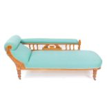 A Victorian satin walnut framed chaise longue, upholstered in green floral fabric, raised on