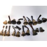 Assorted hand bells, some with hammers, most with tooled leather handles. (19)