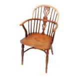 A 19thC yew oak and elm Windsor chair, with vase shaped splat, solid saddle seat, raised on turned