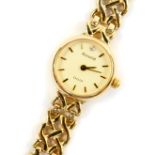 An Accurist lady's 9ct gold cased wristwatch, circular champagne dial with gold batons, diamond